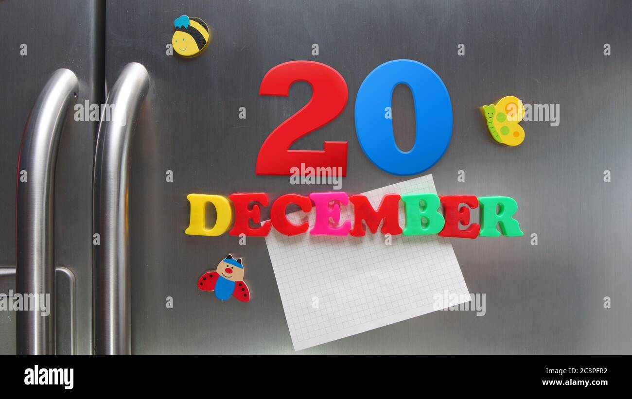 Date du calendrier du 20 décembre faite avec des lettres magnétiques en plastique tenant une note de papier graphique sur le réfrigérateur de porte Banque D'Images