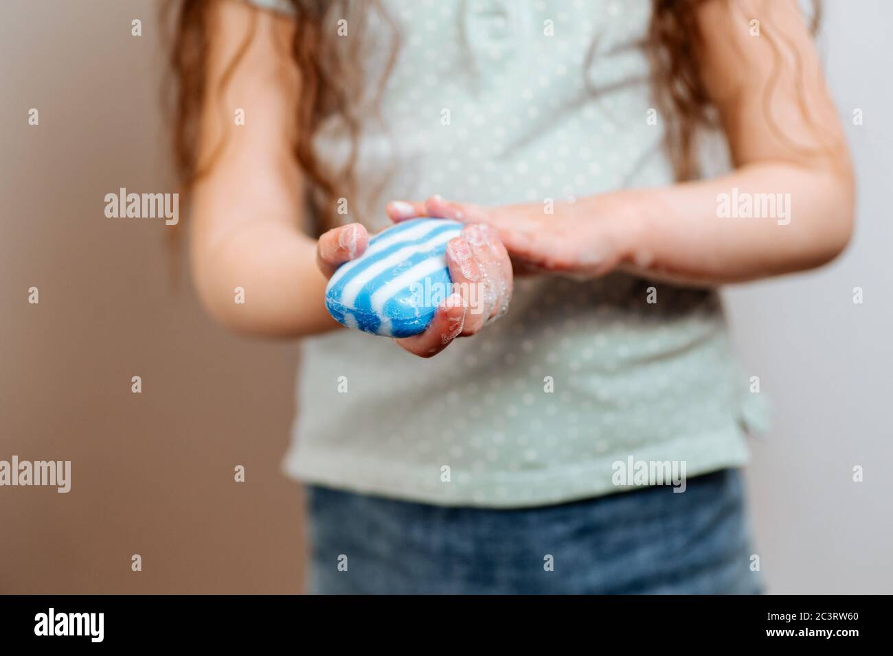 Une petite fille utilise du savon désinfectant pour les mains. Prévention et contrôle des infections à coronavirus COVID-19. Concept d'hygiène et de soins de santé Banque D'Images