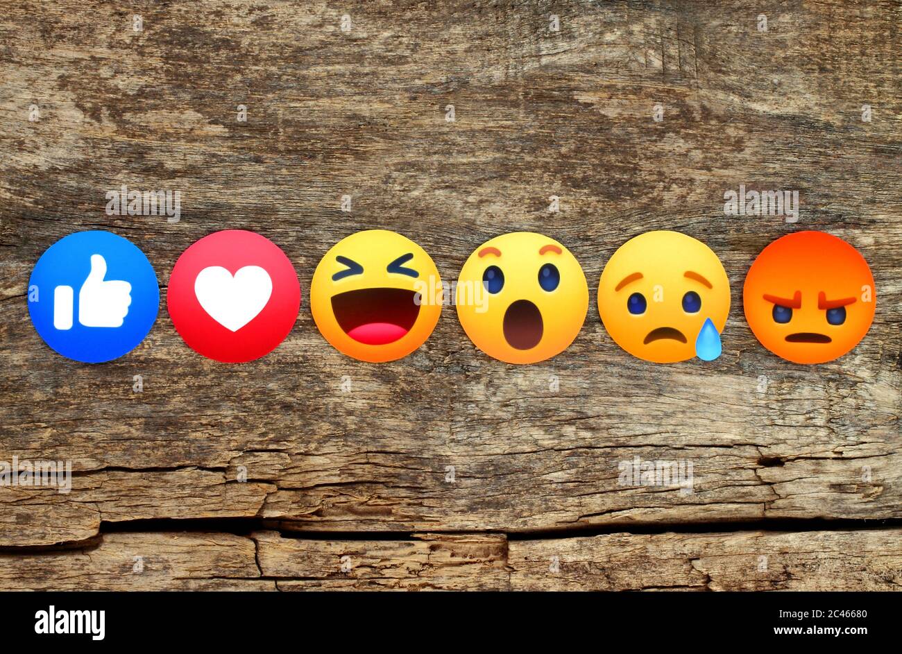 Kiev, Ukraine - 10 mai 2019: Nouveau Facebook Like Button 6 empathique réactions Emoji imprimé sur papier et placé sur fond de bois. Facebook est un nous Banque D'Images