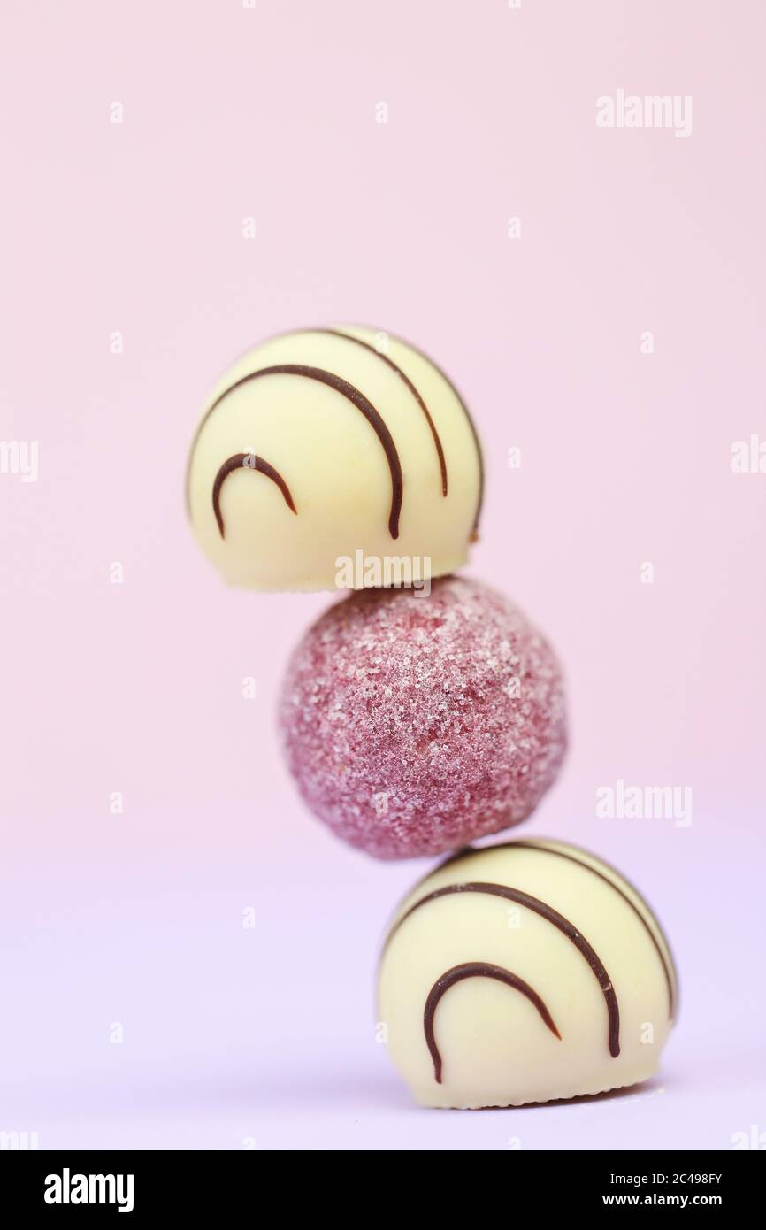 Chocolat au lait blanc et rose sur fond de pastel rose-lilas flou.chocolat assorti.desserts délicieux Banque D'Images