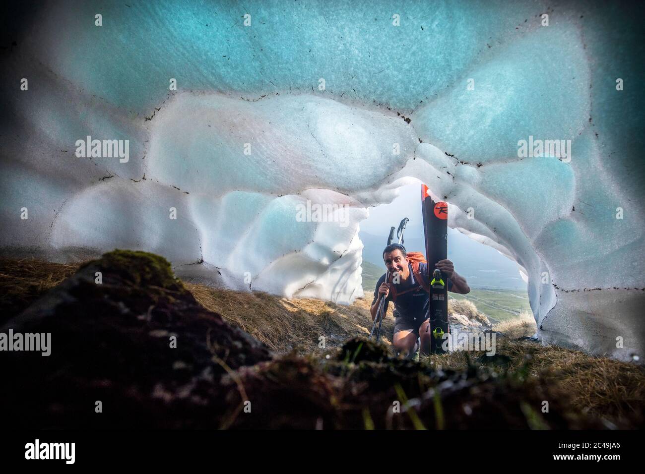 Le skieur Andy Meldrum, propriétaire du Glencoe Mountain Resort, regarde à l'intérieur d'un tunnel de neige formé sous l'une des couches de neige restantes sur les pentes de Meall a'Bhuiridh à Glencoe, car jeudi pourrait être le jour le plus chaud de l'année au Royaume-Uni avec des températures brûlants qui devraient augmenter encore davantage. Banque D'Images