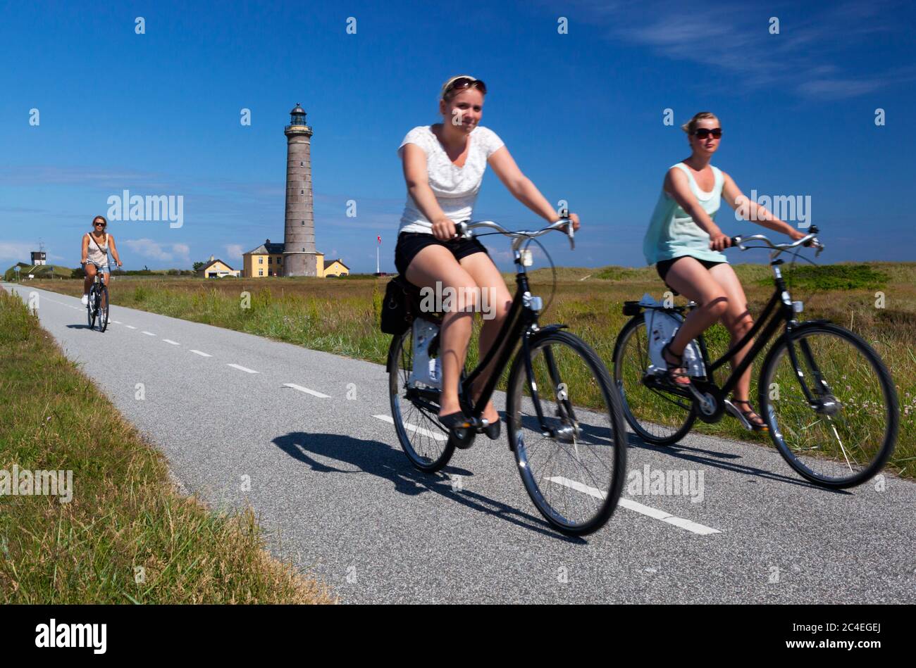 Cyclistes sur le sentier cyclable le long de Fyrvej avec Skagen FYR (phare) derrière, Skagen, Jutland, Danemark, Europe Banque D'Images