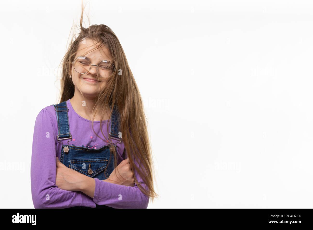 Une fille de onze du vent s'emmêle dans de longs cheveux Banque D'Images