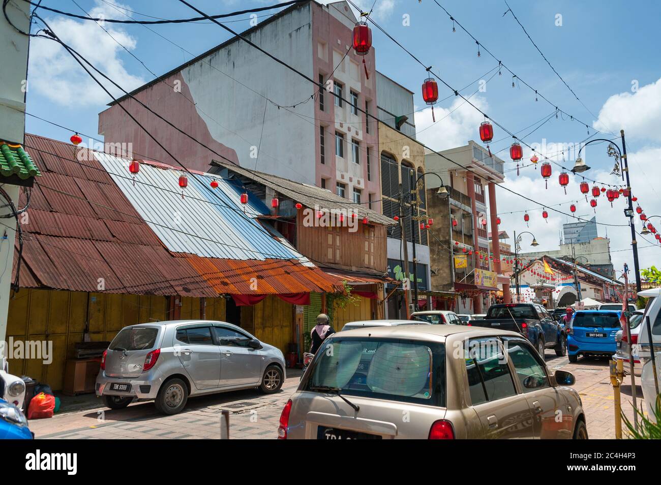 Rues colorées de Chinatown (Kampung Cina), site important du patrimoine de Terengganu. Lanternes, magasins, rue animée avec bleu, fond de ciel nuageux Banque D'Images