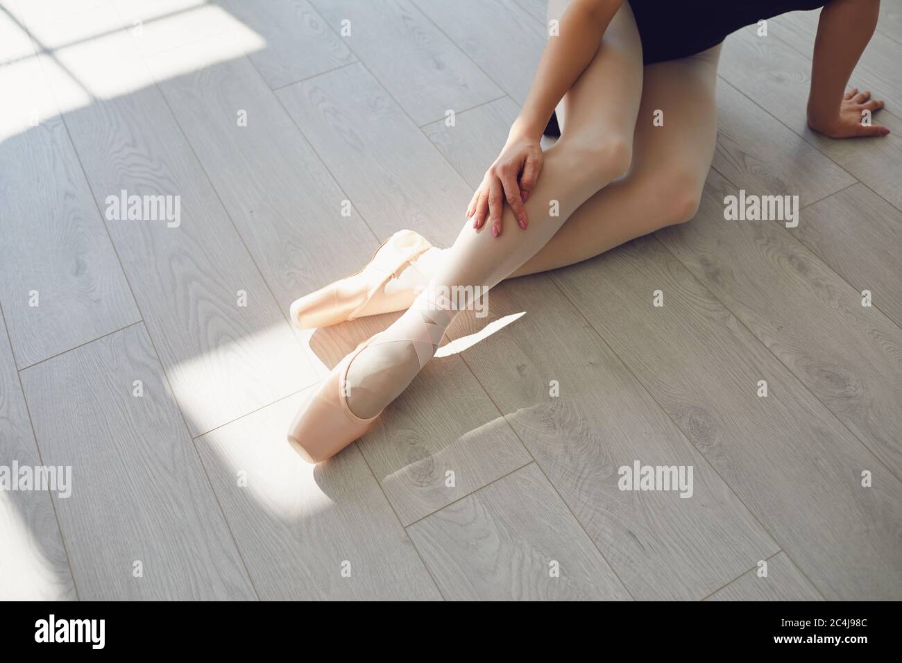 Ballet. Ballerine. Jambes d'une ballerina sur le sol en classe studio. Banque D'Images