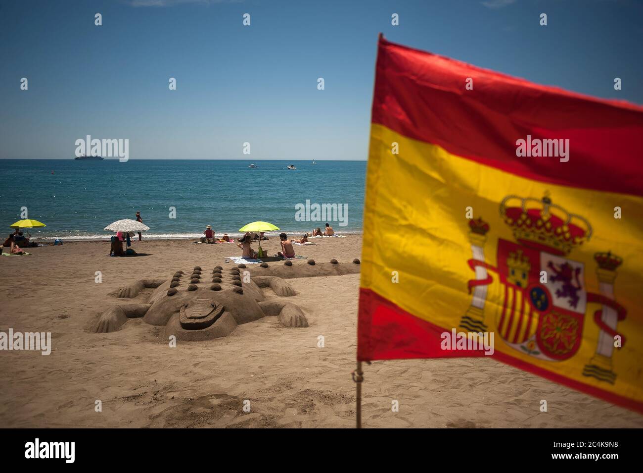 Une sculpture de crocodile de sable est vue à la plage de la Caleta comme un drapeau espagnol vagues pendant une chaude journée d'été.UNE vague de chaleur traverse le pays avec des températures élevées, selon l'Agence espagnole de météorologie. Banque D'Images
