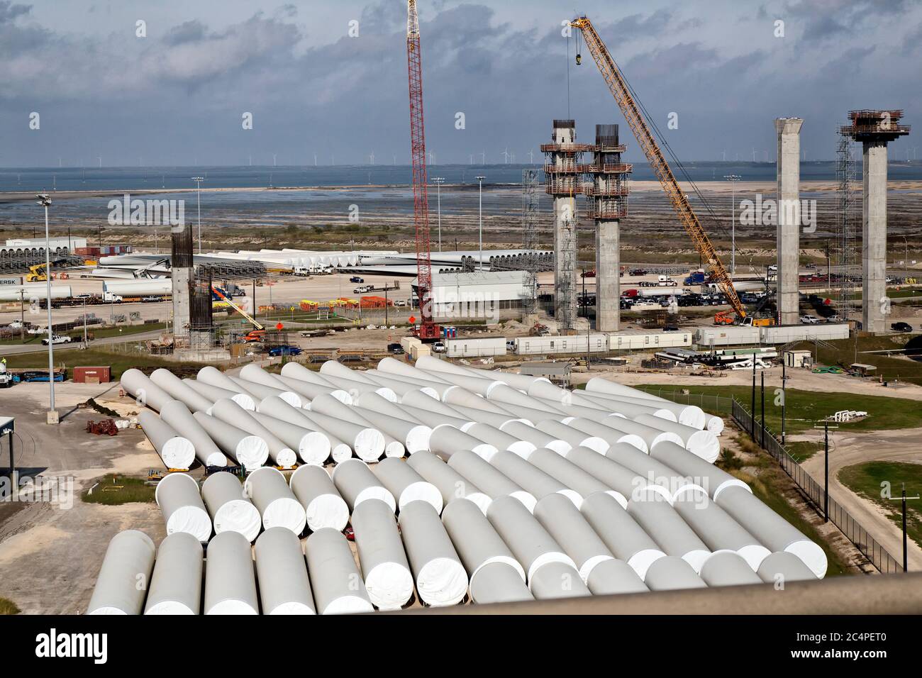 Surplombant la construction du pont du port de New Corpus Christi, pièces d'éoliennes en premier plan/arrière-plan en entreposage, Corpus Christi, Texas. Banque D'Images