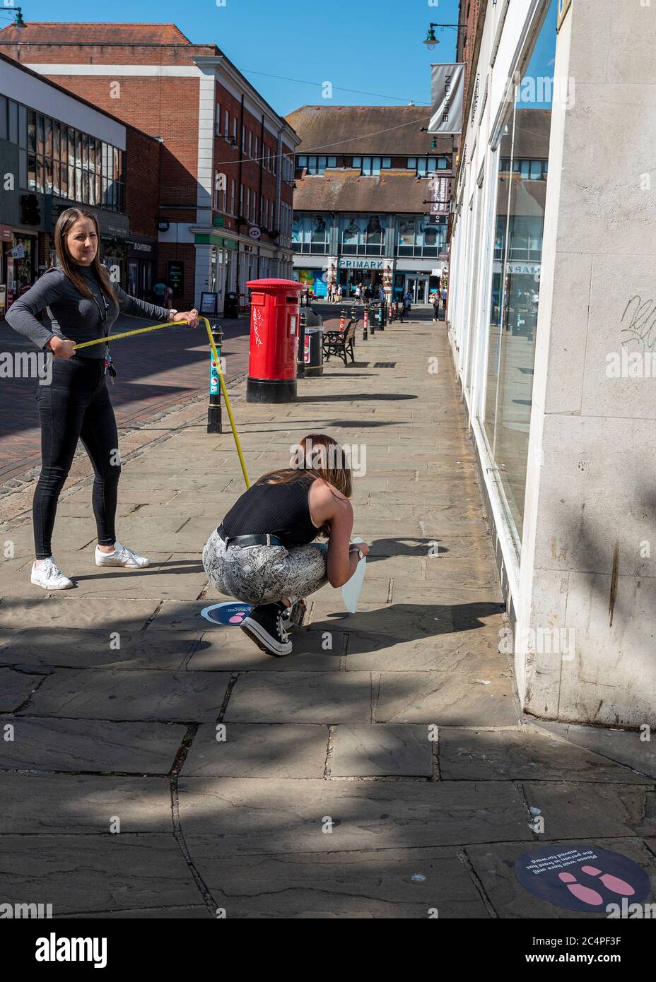 Le premier jour où des magasins non essentiels ont ouvert leurs portes à Canterbury, dans le Kent, au Royaume-Uni, après un confinement de la cavid-19. Deux travailleurs mesurent et posent des marqueurs de distance Banque D'Images Le premier jour où des magasins non essentiels ont ouvert leurs portes à Canterbury, dans le Kent, au Royaume-Uni, après un confinement de la cavid-19. Deux travailleurs mesurent et posent des marqueurs de distance Banque D'Images