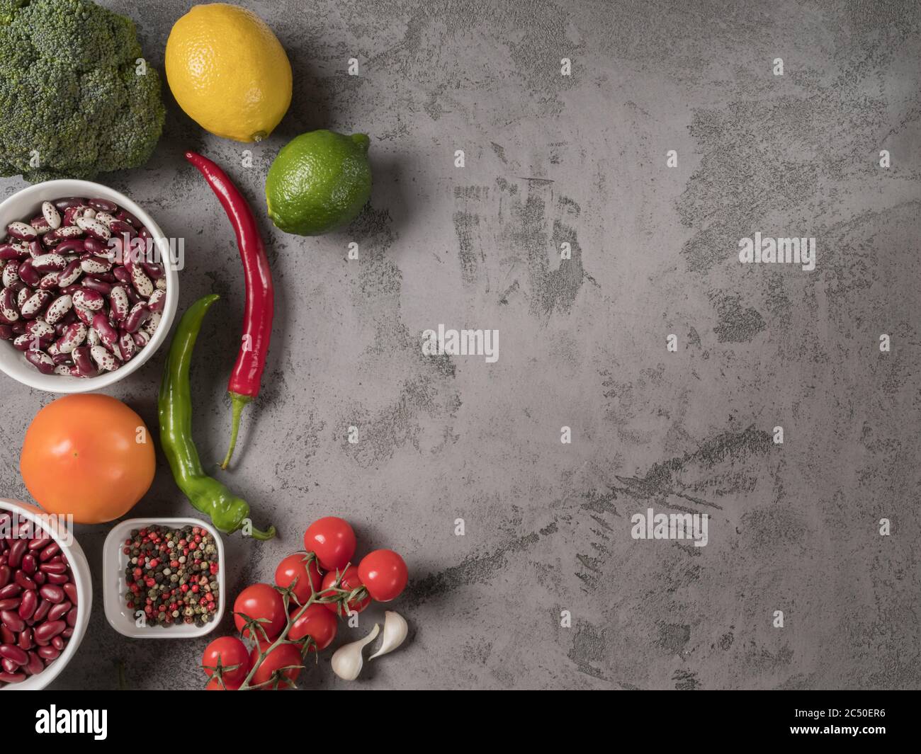 Légumes, haricots et épices biologiques sur fond gris. Banque D'Images