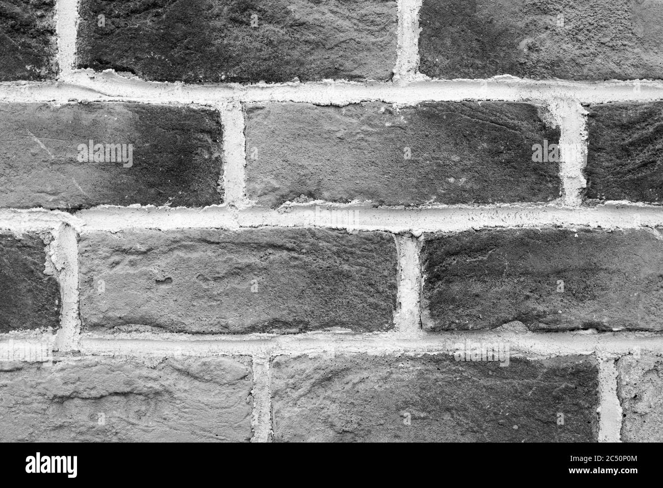 Gros plan sur un mur en briques noir et blanc fait main, loft. Fond ou texture qualitatif. Banque D'Images