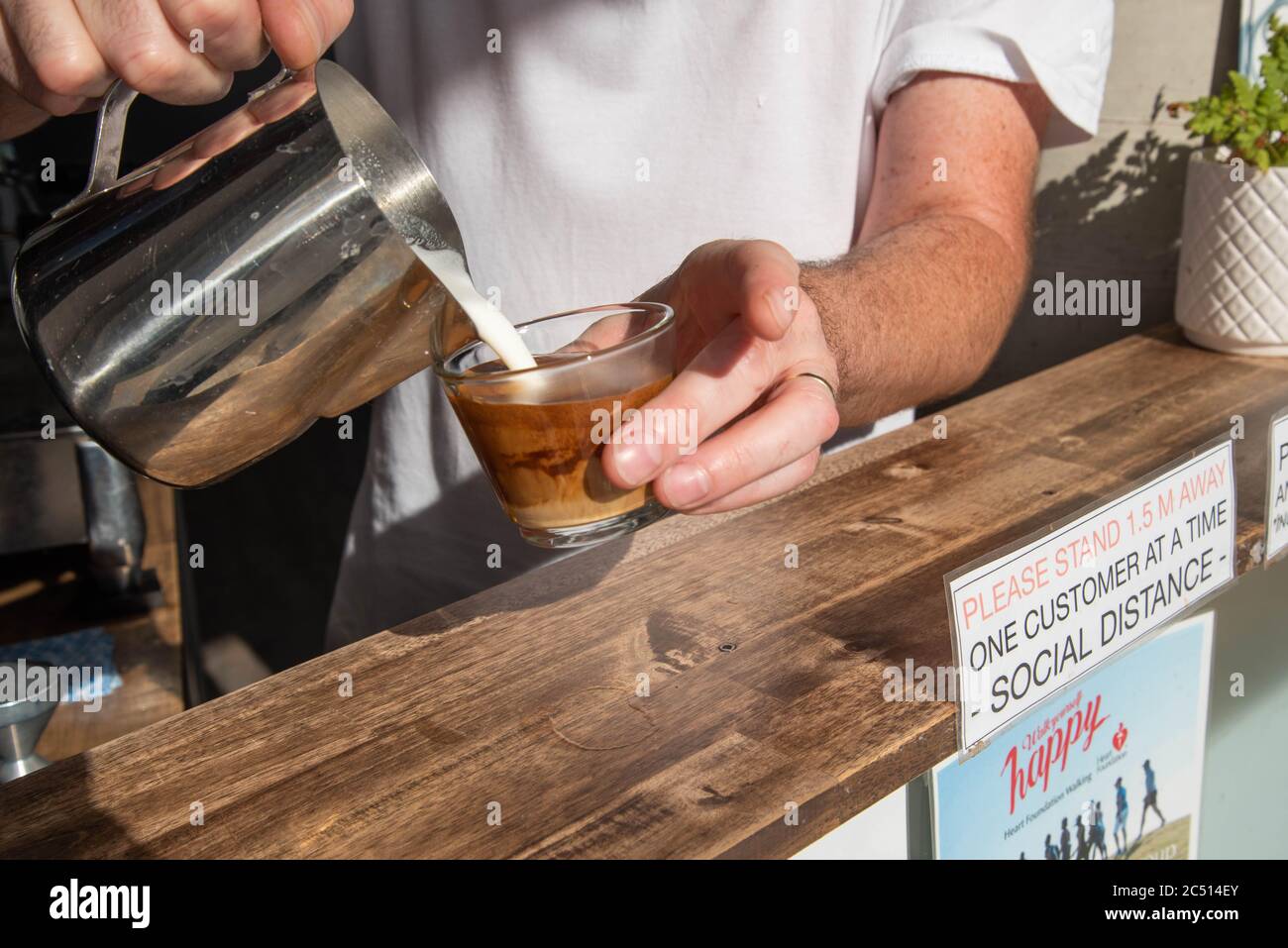Brisbane, Australie. 30 juin 2020. Un barista sert un café près d'un panneau pour vous informer sur les distances sociales au milieu de la crise Covid-19.le Premier ministre du Queensland, Annastacia Palaszczuk, participe à une réunion du cabinet d'un État le mardi 30 juin pour annoncer une réouverture possible de la frontière et des recommandations sanitaires. (Photo de Flo Rols/Pacific Press) crédit: Agence de presse du Pacifique/Alamy Live News Banque D'Images