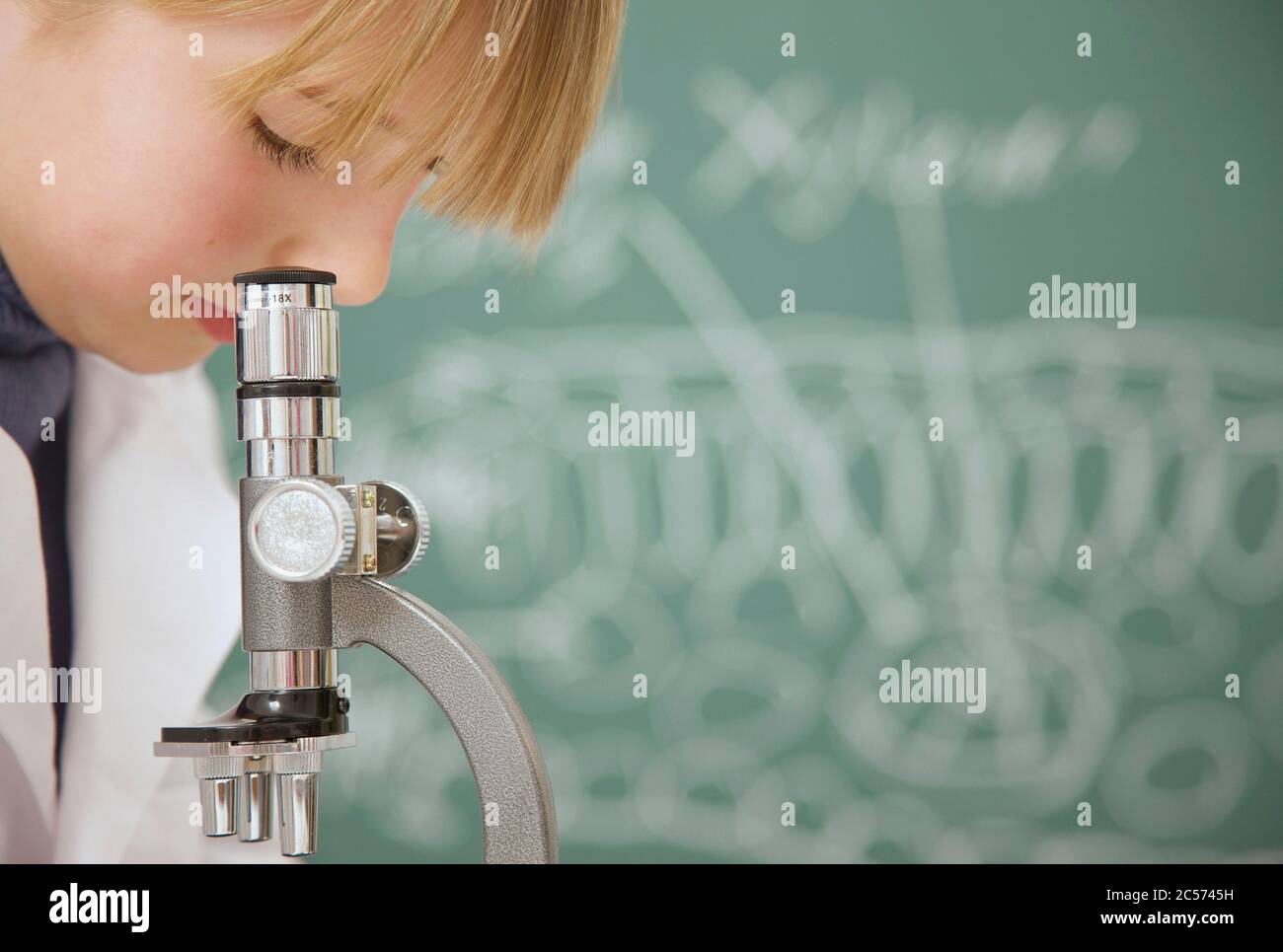 Gros plan junior école secondaire jeune fille étudiant à l'aide du microscope Banque D'Images