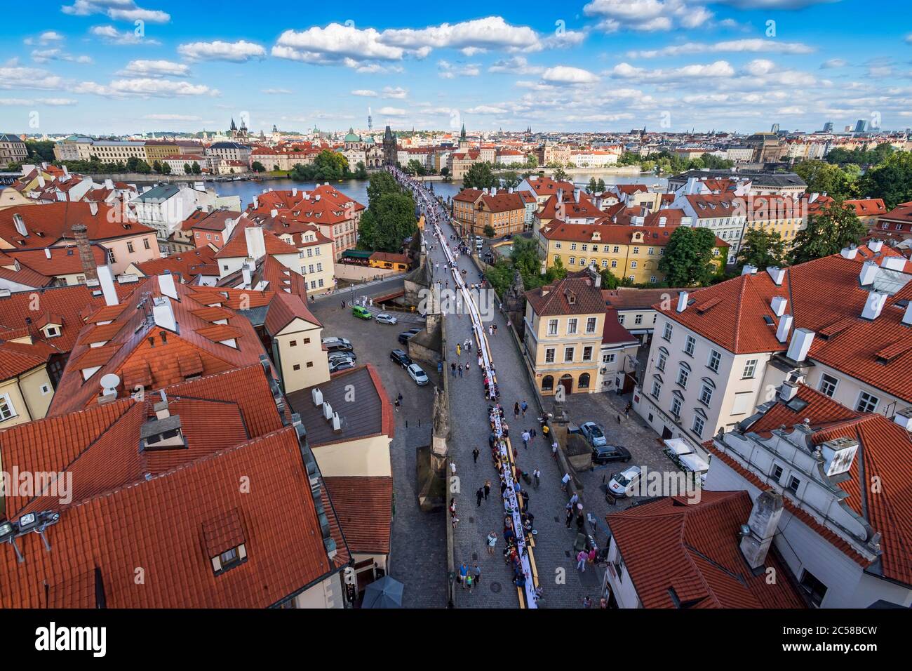 Des milliers de personnes se sont assises à une table de 500 mètres de long sur le pont Charles de Prague, où elles partageait nourriture et boissons de leur domicile Banque D'Images
