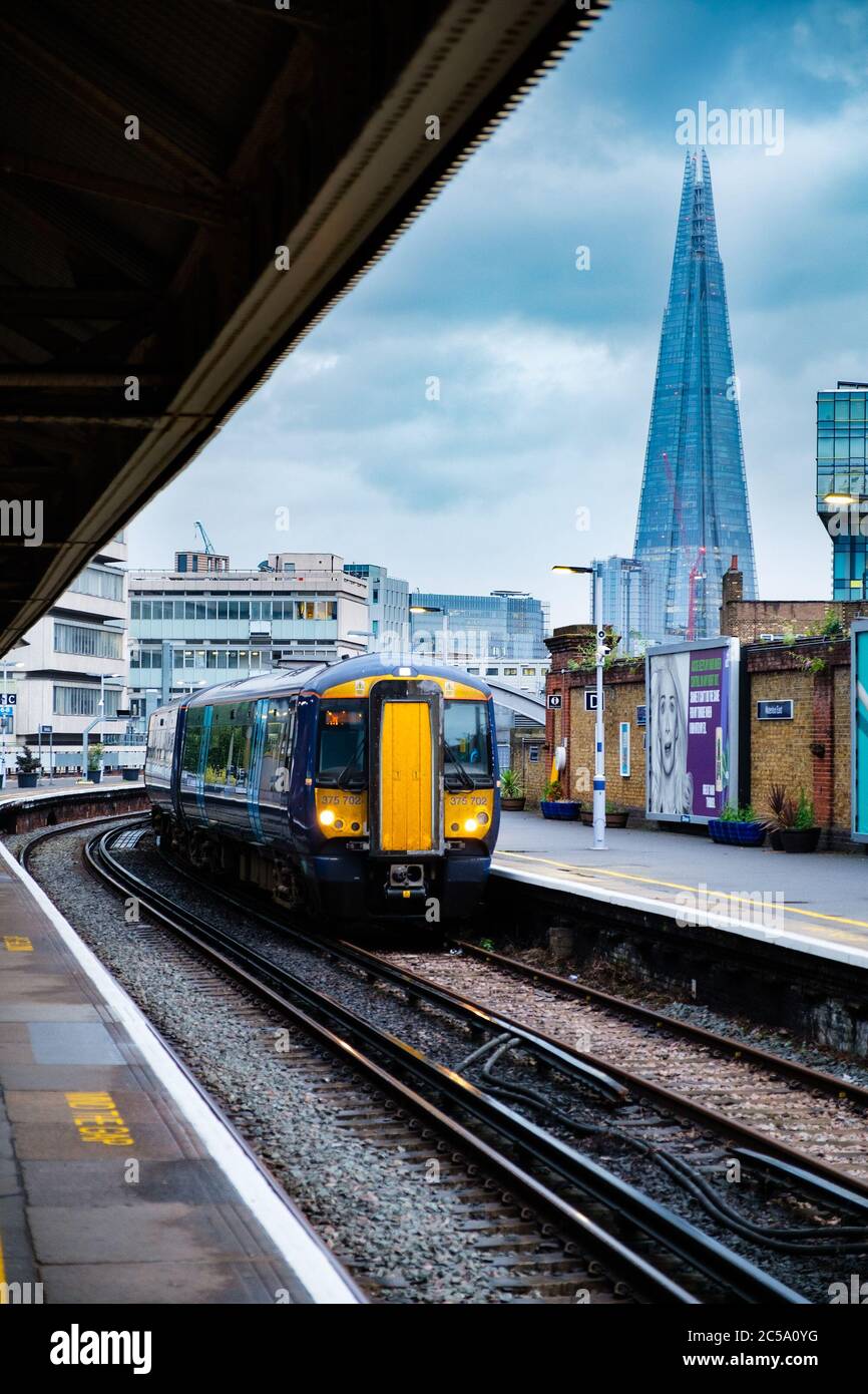 Train arrivant à la gare de Waterloo à Londres avec vue sur le gratte-ciel de Shard en arrière-plan Banque D'Images