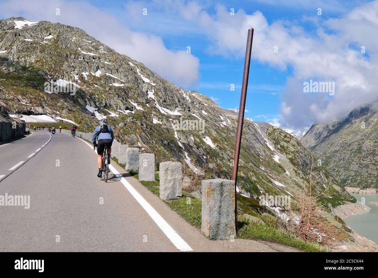 Cycliste sur le col Grimsel dans les Alpes suisses, qui relie l'Oberland bernois au Haut-Valais, en Suisse Banque D'Images