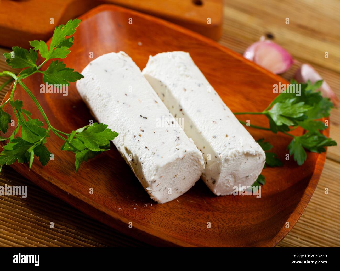 Délicat fromage de chèvre au lait salé avec herbes piqueuses et ail sur l'assiette Banque D'Images