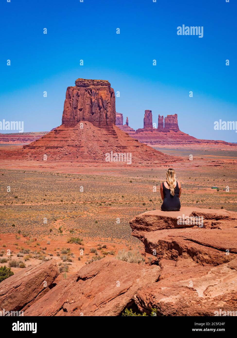 Une jeune fille blonde admire le panorama depuis Artist's point dans la vallée du monument d'Oljato Banque D'Images