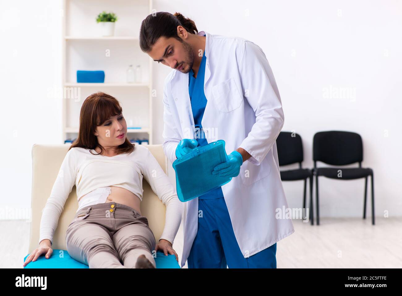 Une jeune femme blessée en visite chez un médecin de sexe masculin Photo  Stock - Alamy