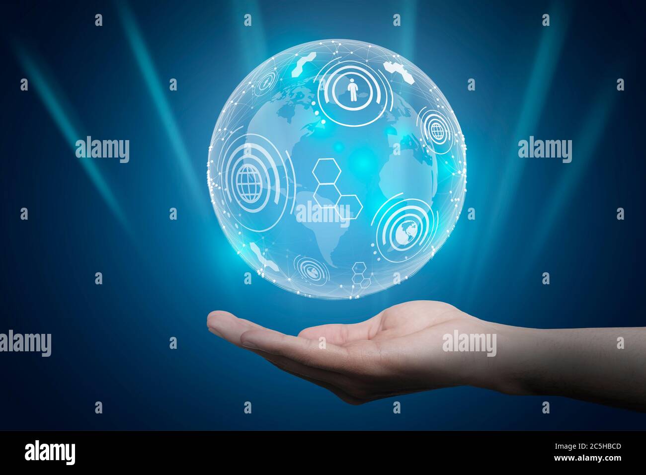 Main tenant Holographic World Globe avec icônes Web, fond bleu Banque D'Images