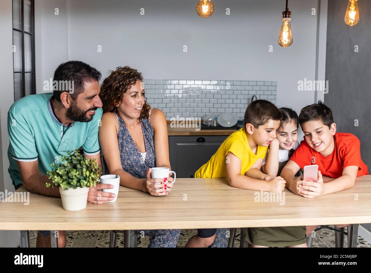 Une famille nombreuse et heureuse, connectée à la technologie Banque D'Images