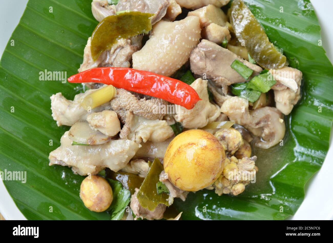 poulet cuit épicé et salade d'œufs sur feuille de banane dans l'assiette Banque D'Images