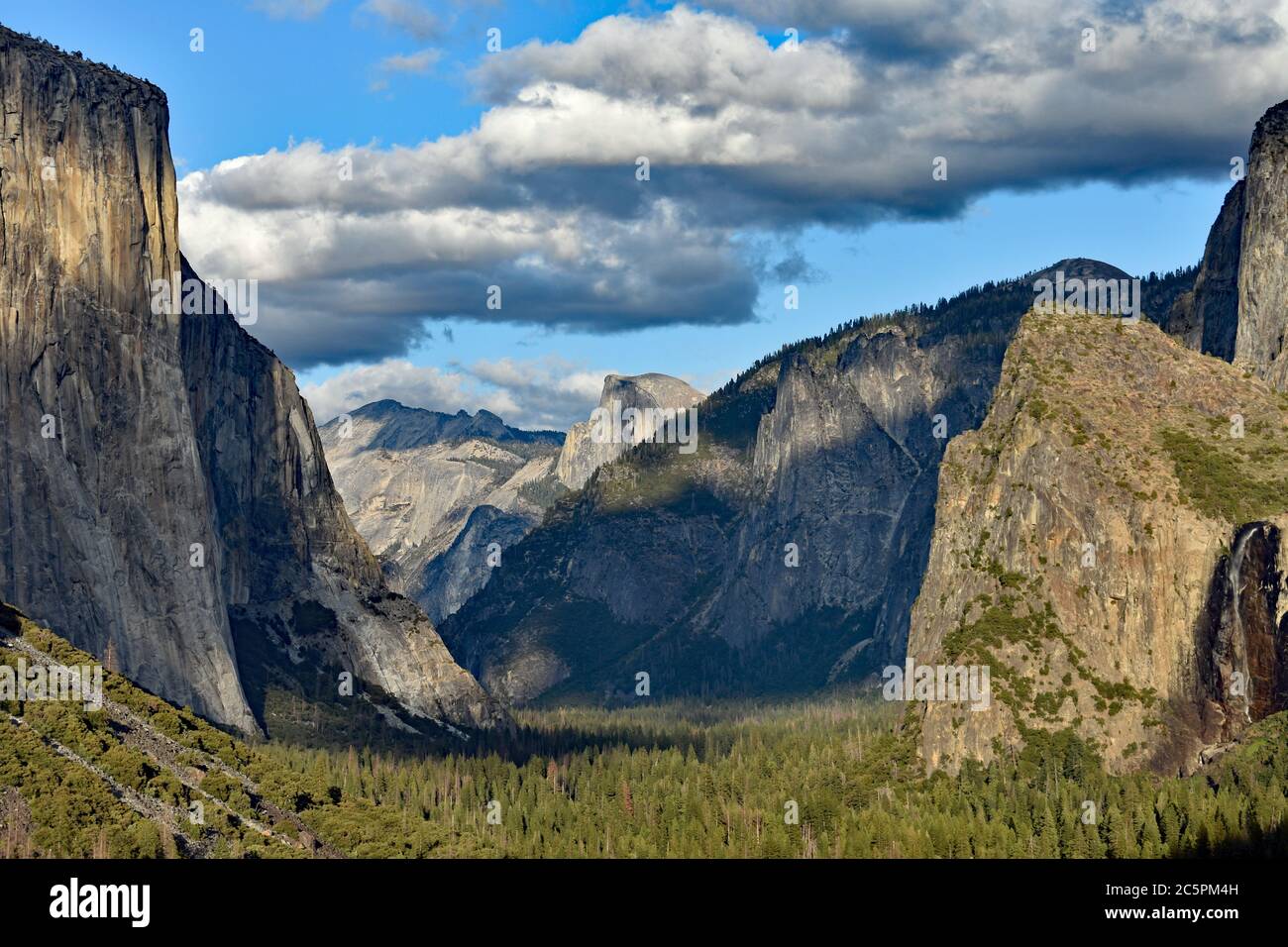 Vue sur le tunnel dans le parc national de Yosemite, Californie. Vue sur El Capitan, les sommets de la cathédrale, les chutes de la mariée de Veil et demi-dôme au coucher du soleil. Banque D'Images
