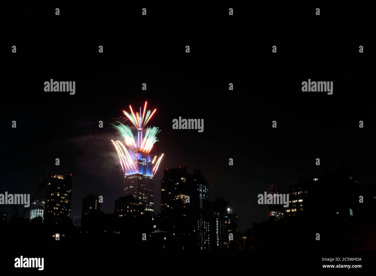 New York, New York, États-Unis. 4 juillet 2020. Des feux d'artifice sont lancés depuis le sommet de l'Empire State Building à New York le samedi soir, dans ce qui a été une célébration très discrète dans la plupart des États-Unis du 4 juillet, la Journée de l'indépendance américaine. Le moment et l'emplacement des feux d'artifice à New York n'ont pas été annoncés à l'avance afin d'empêcher la formation de foules pour les voir, étant donné la pandémie du coronavirus et la crise de santé publique qui existe encore. Crédit : Adam Stoltman/Alamy Live News Banque D'Images