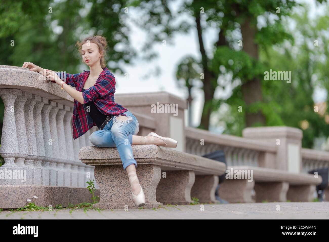 Ballerine fille en jeans, une chemise à carreaux et des chaussures de  pointe dansant dans la ville dans la rue Photo Stock - Alamy
