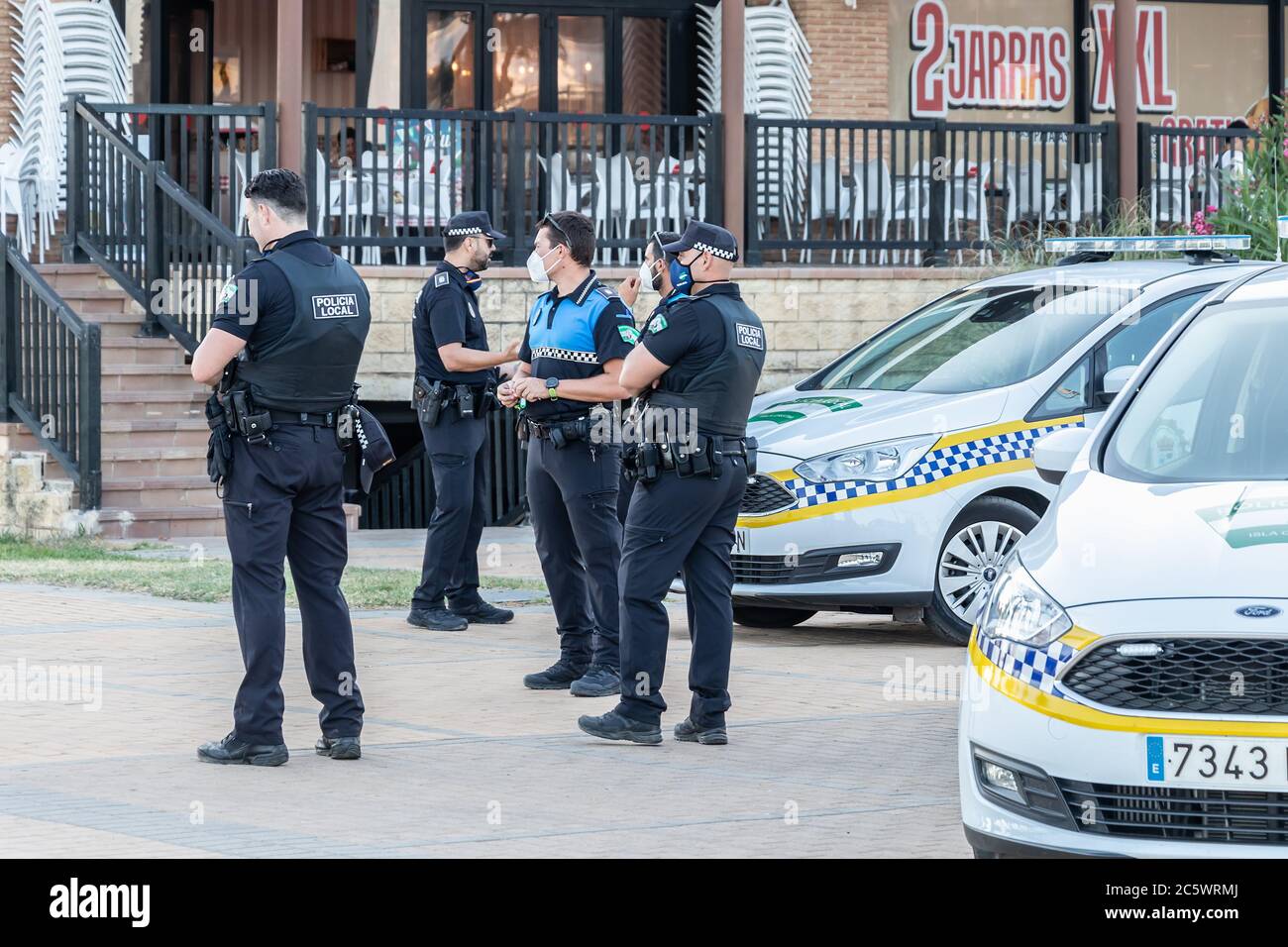 Huelva, Espagne - 4 juillet 2020: Police espagnole avec logo de la police locale sur l'uniforme maintenir l'ordre public dans la promenade de la plage d'Islantilla Banque D'Images
