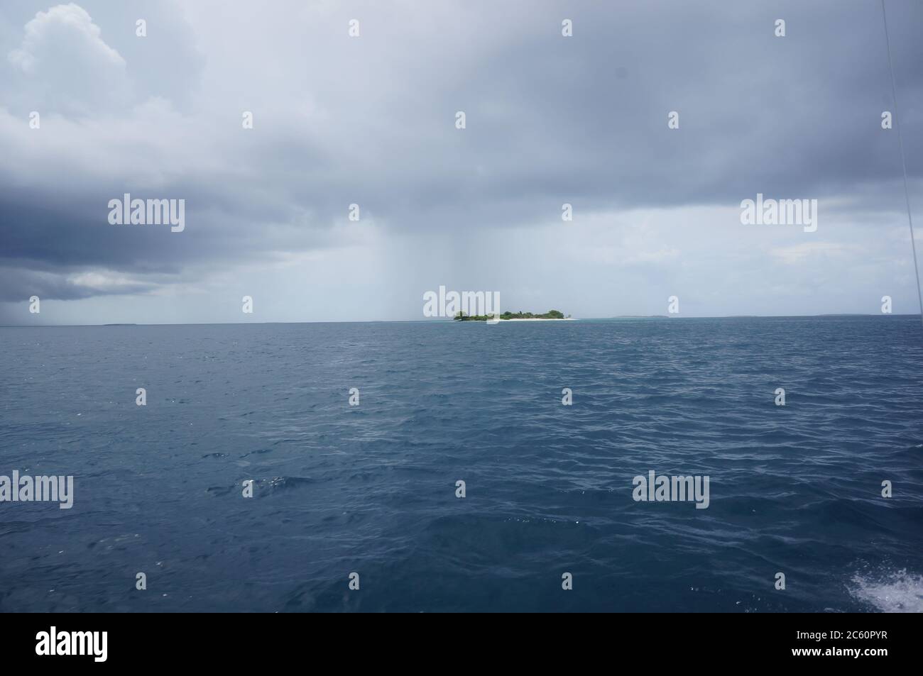 Île des Maldives avec un nuage de pluie Banque D'Images