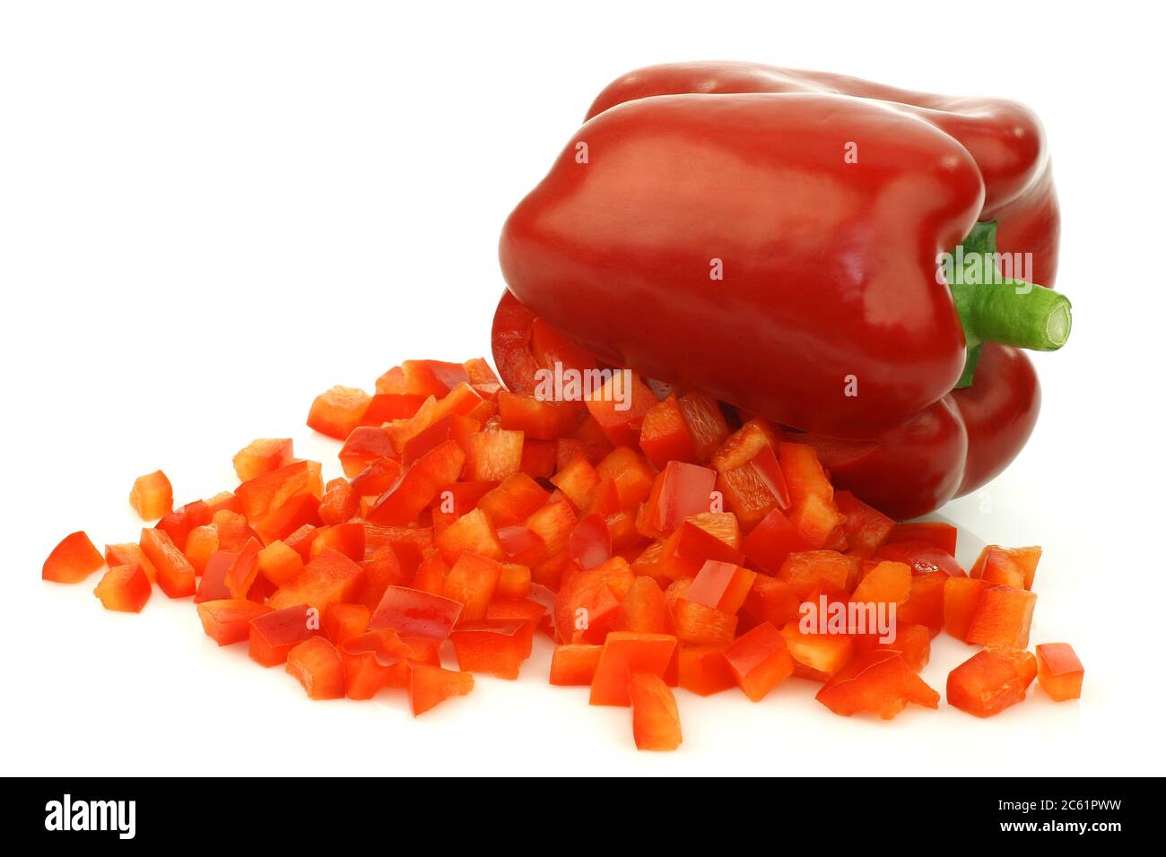 poivron rouge frais avec face avant ouverte et morceaux de paprika déjà coupés sortant sur un fond blanc Banque D'Images