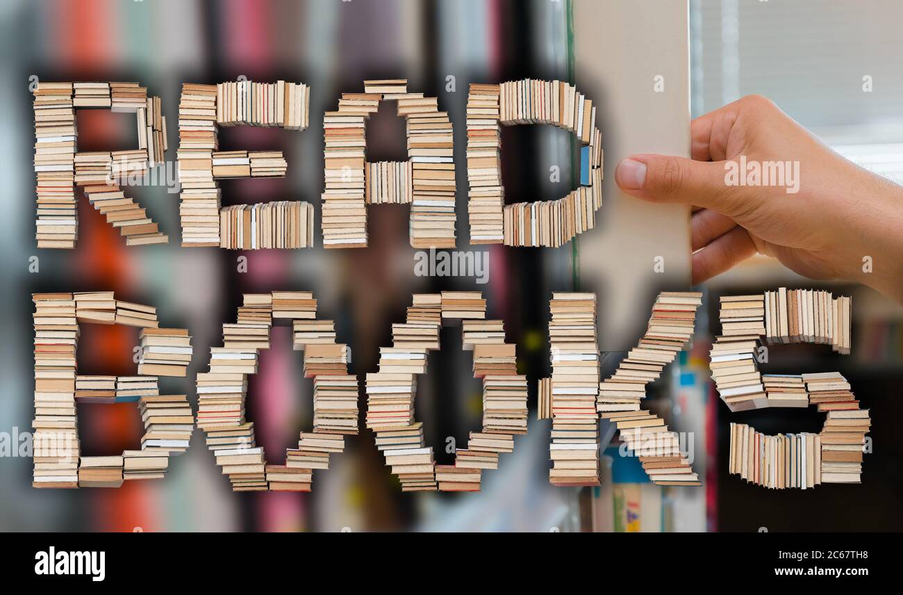 Lire des livres lettres avec un jeune étudiant en choisissant un livre de la tablette dans la bibliothèque en arrière-plan. Banque D'Images