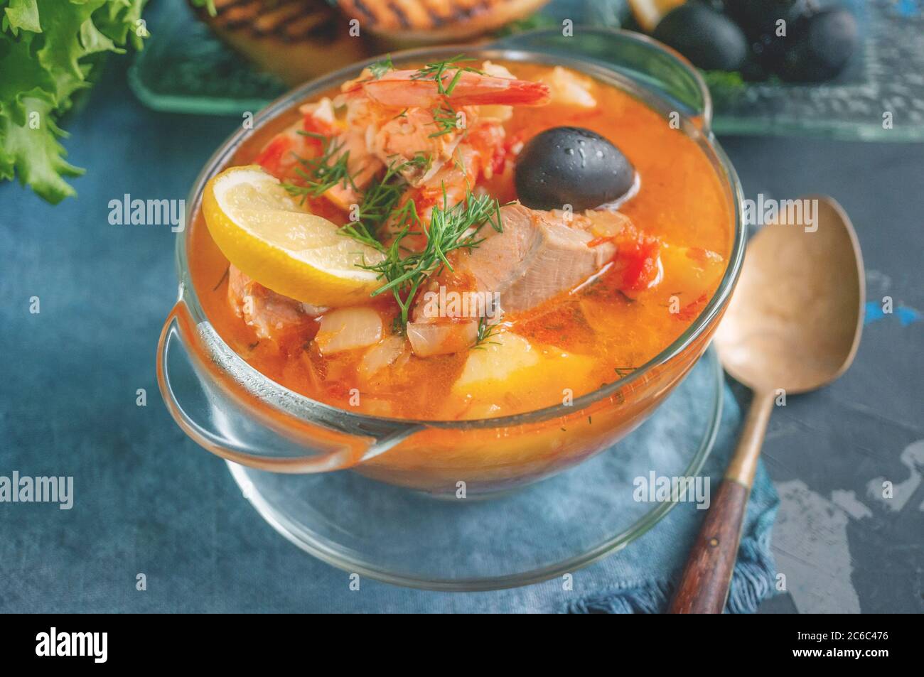 Les fruits de mer, saumon et soupe à la morue avec des pommes de terre. Servi avec du citron, les olives et délicieux croûtons de pain blanc. Banque D'Images