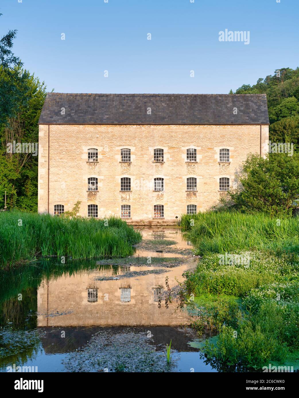 Le moulin du Belvédère se reflète dans la rivière depuis la lumière du matin. Chalford, Cotswolds, Stroud, Gloucestershire, Angleterre Banque D'Images