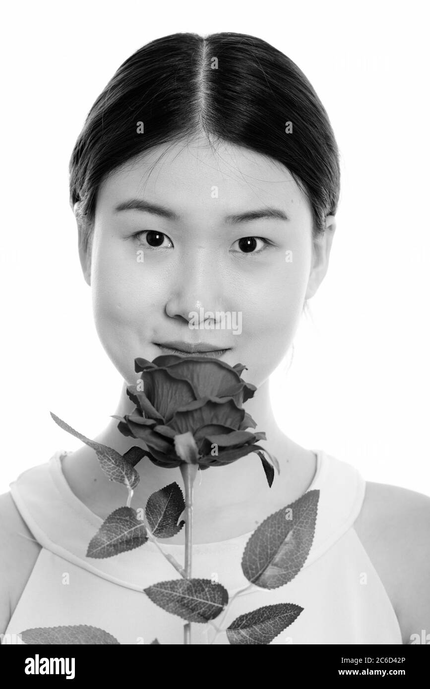 Visage de jeune belle Asian woman holding red rose Banque D'Images