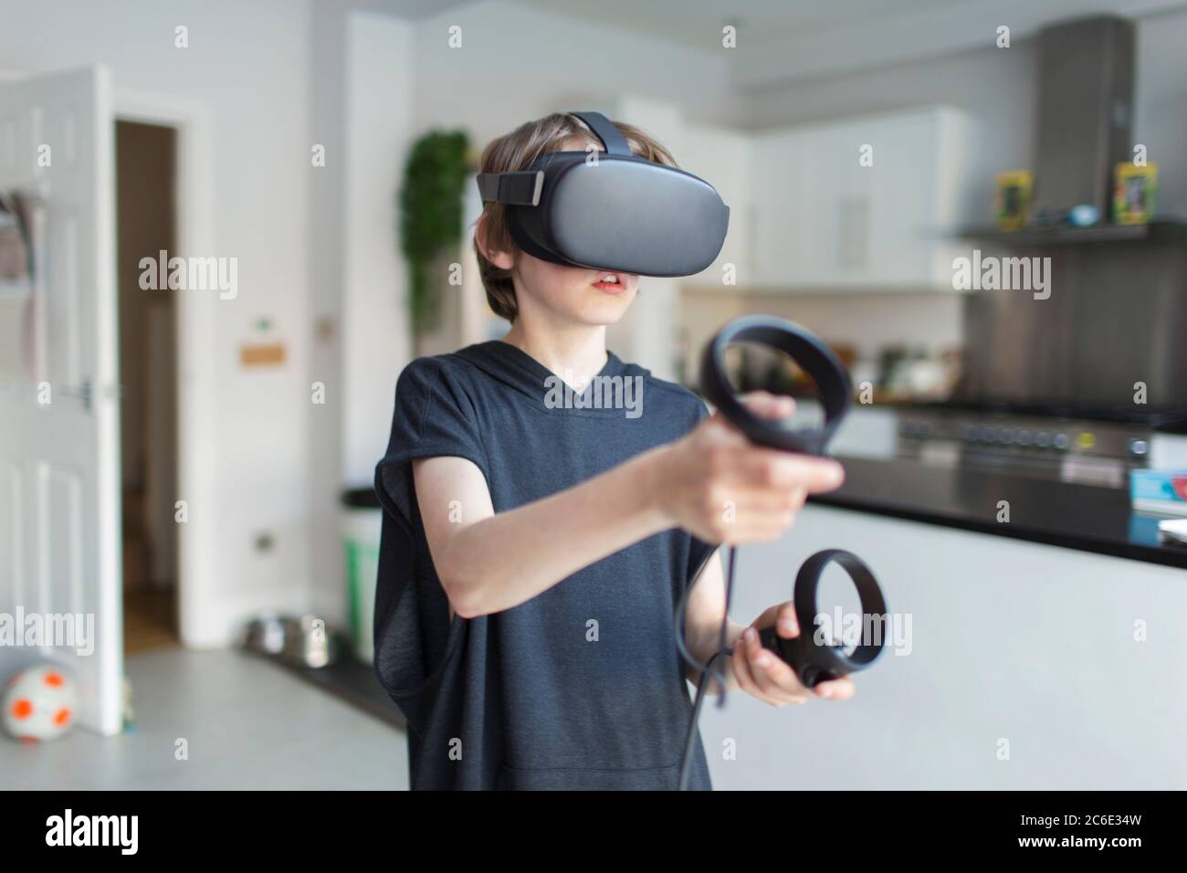 Garçon avec des lunettes VRS jouant à un jeu vidéo Banque D'Images