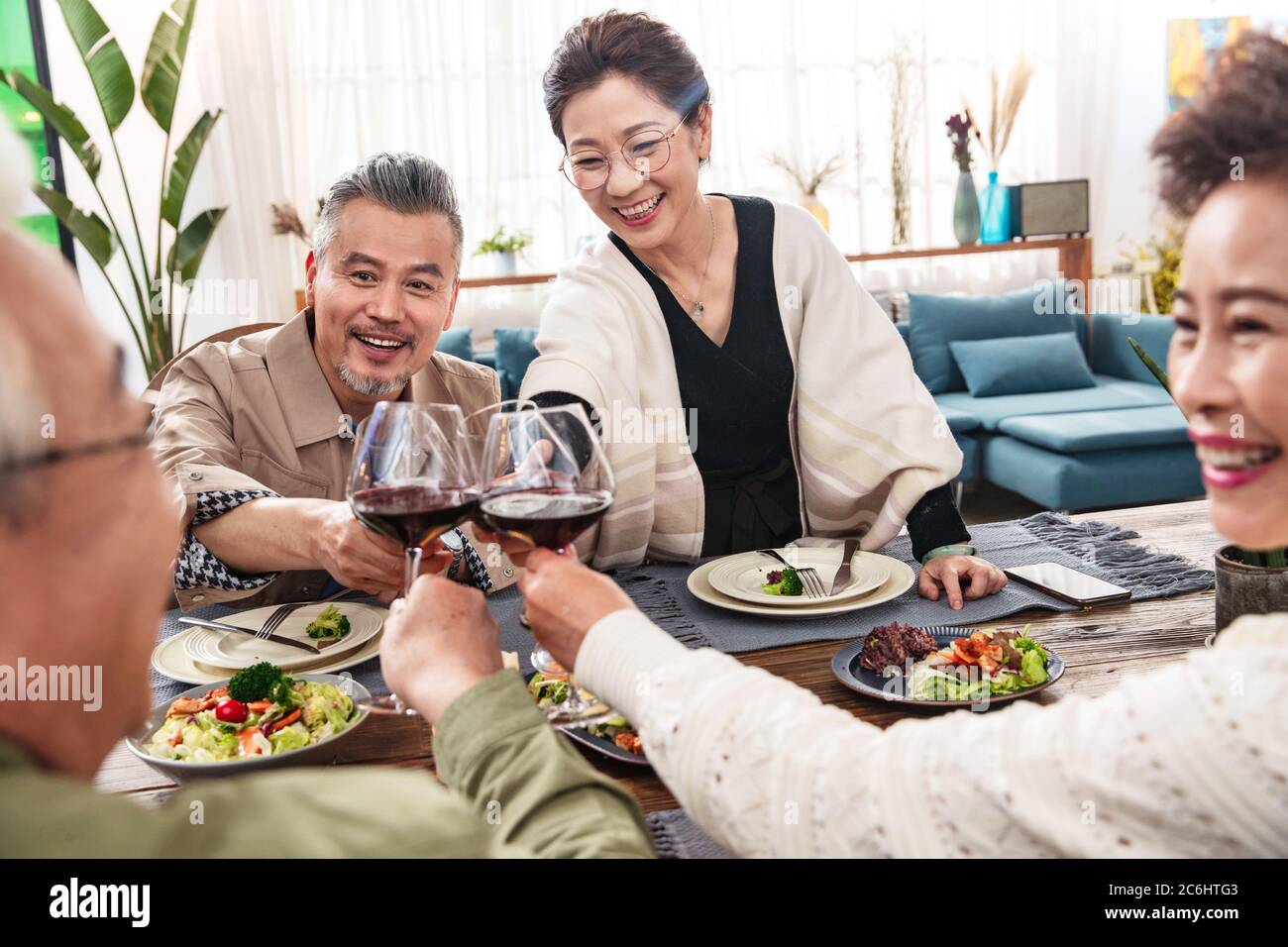 Des toasts heureux pour les couples d'âge moyen Banque D'Images
