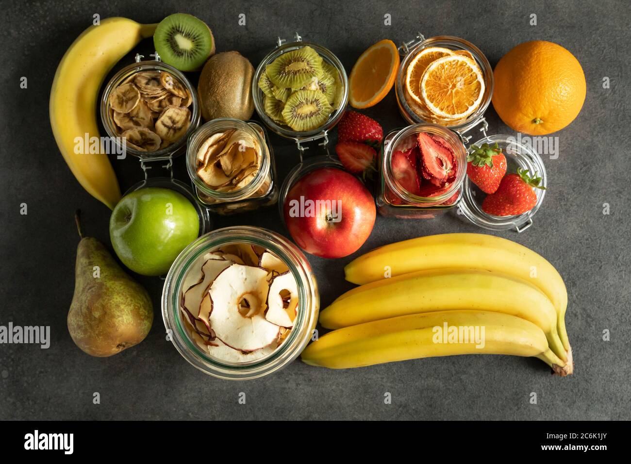 Fruits secs et chips de fruits avec les fruits frais dont ils sont faits. Nutrition alimentaire. Des collations naturelles et saines. Banque D'Images