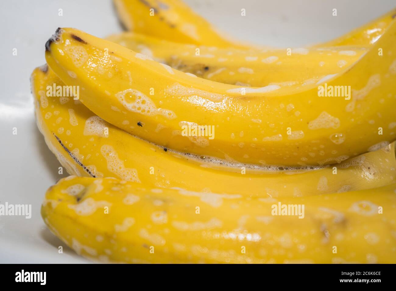Nettoyez les bananes avec du savon dans l'évier. Lavage des fruits après achat. Prévention des virus Banque D'Images