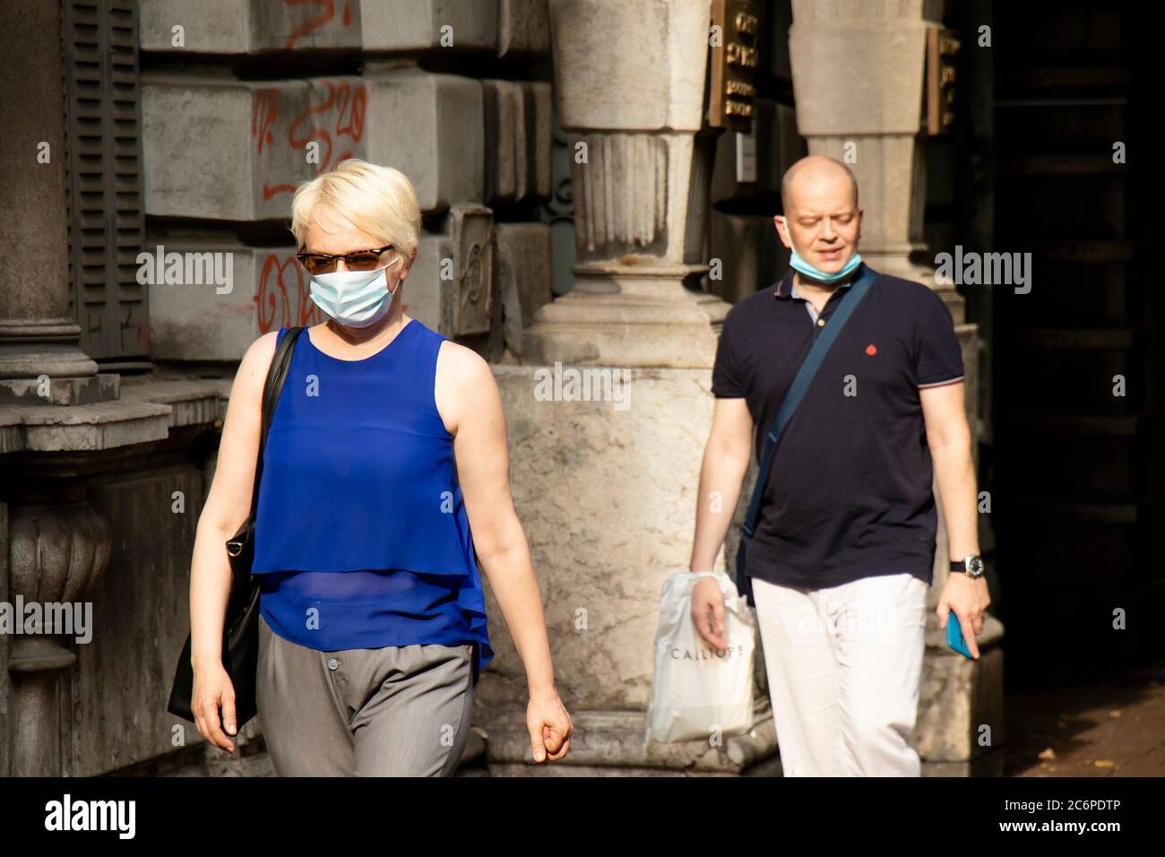 Belgrade, Serbie - 3 juillet 2020 : les personnes portant un masque chirurgical se promusent dans la rue de la ville le jour d'été Banque D'Images