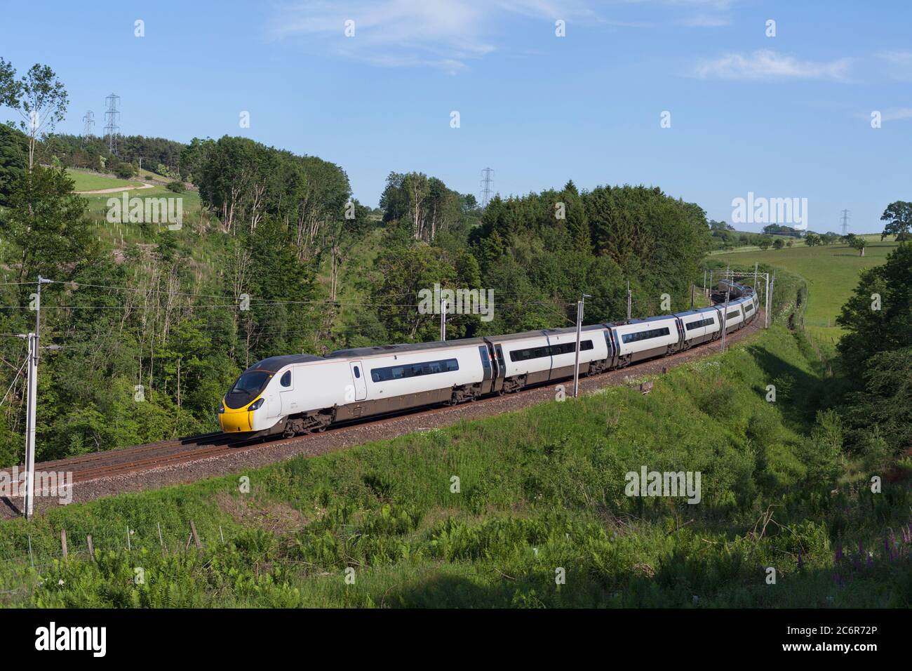 Première Trenitalia Avanti West Coast Alstom Pendolino train 390124 inclinable en suivant une courbe sur la ligne principale de la côte ouest Banque D'Images