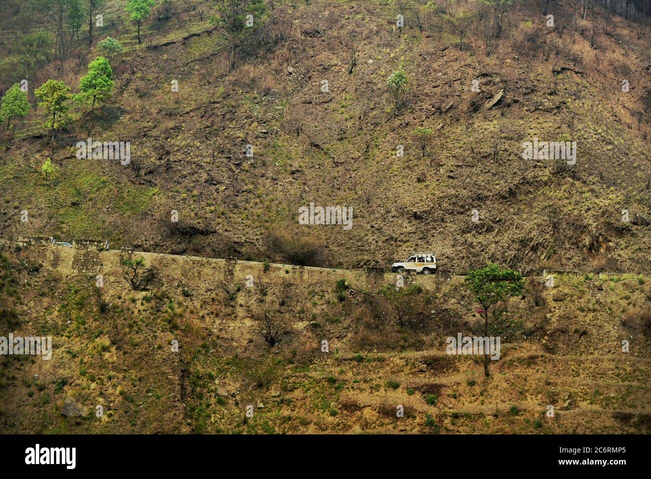 Véhicule qui se déplace sur une route, qui fait partie du réseau routier stratégique (SRN) du Népal, qui s'est établi sur une pente abrupte à la limite de la vallée de Katmandou, à la périphérie de la ville de Katmandou, au Népal. Photo d'archives (2016). Le réseau routier au Népal a subi des dommages modérés à la suite du tremblement de terre de 2015. Le montant total des dommages estimés au réseau routier stratégique (SRN) s'élevait à 45.9 millions de dollars, tandis que les pertes totales étaient estimées à 5.26 millions de dollars. Sur le réseau routier local (RRN), le montant total des dommages estimés était de 124.85 millions de dollars, tandis que les pertes totales étaient de 42.74 millions de dollars. Banque D'Images