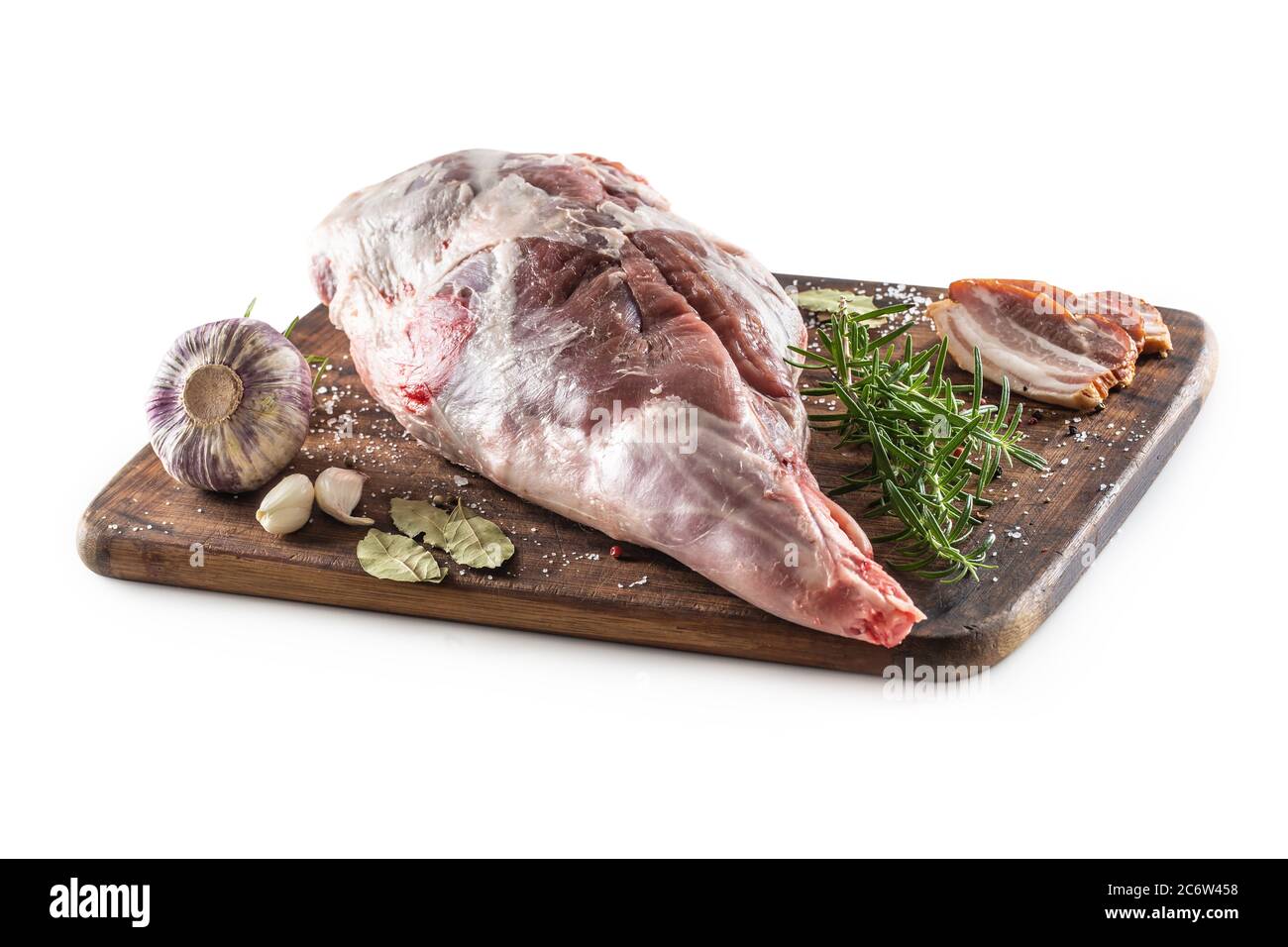 Hache d'agneau non cuite sur une planche à découper entourée de assaisonnements sur un fond blanc isolé Banque D'Images