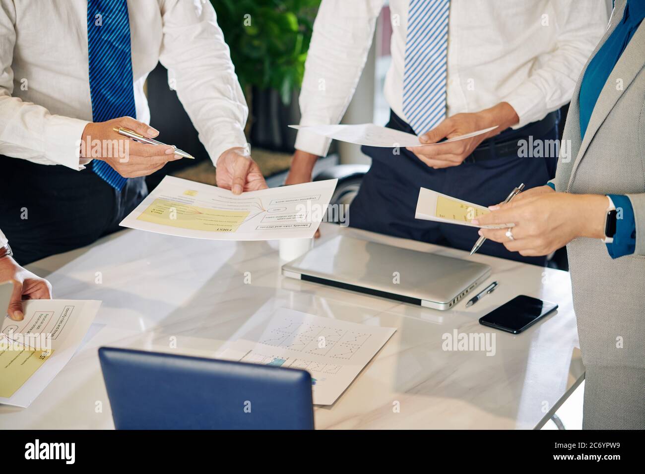 Image rognée des gestionnaires financiers discutant de l'impact économique de la pandémie de Covid-19 sur l'entreprise Banque D'Images