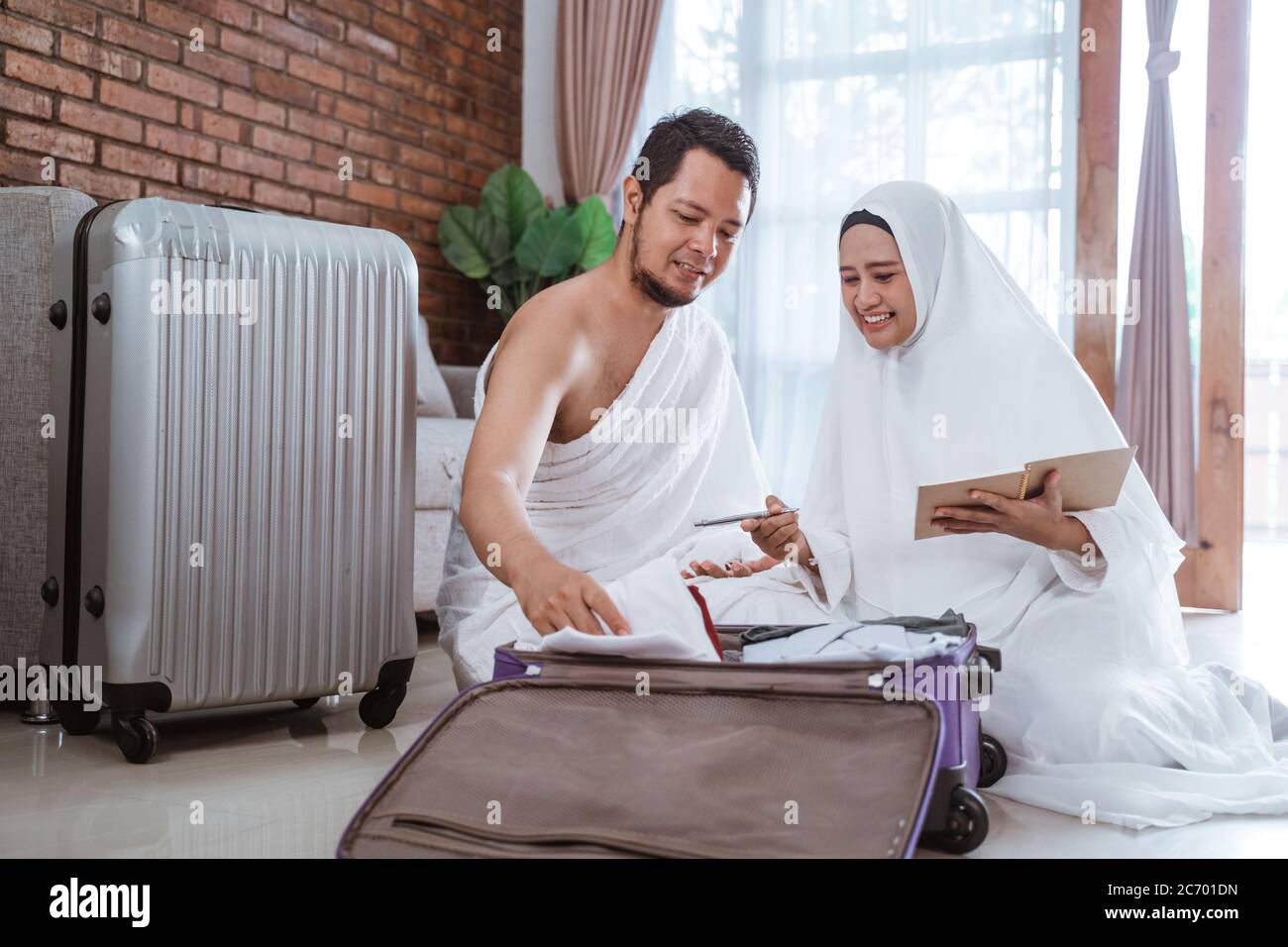 Pèlerins musulmans femme et mari préparer article pour Hajj visiter Kaaba Banque D'Images