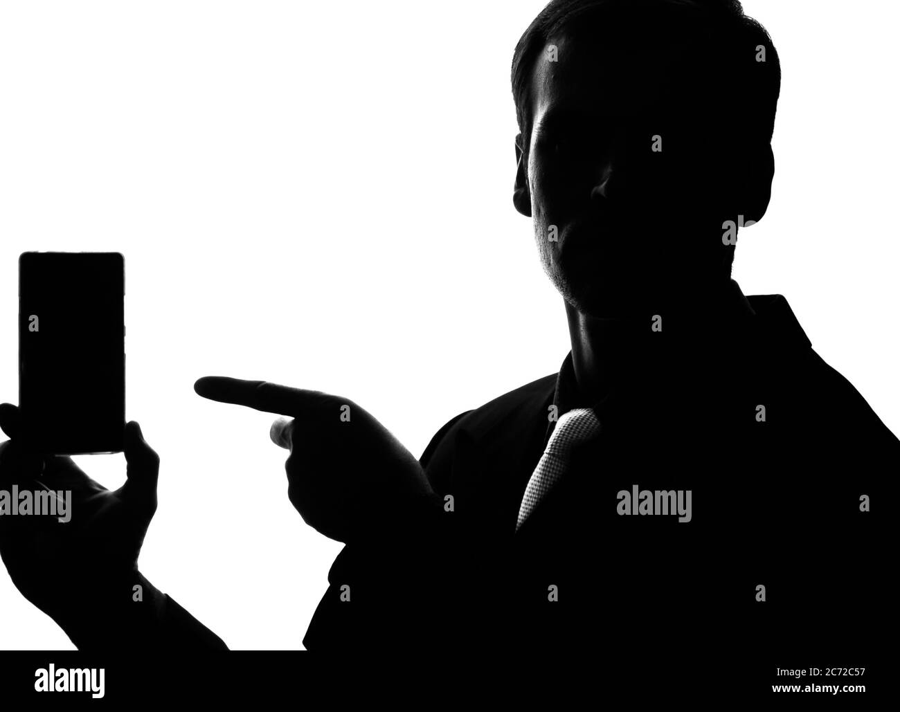 Portrait d'un jeune homme en costume et point d'attache sur un smartphone, tablette à la main - silhouette Banque D'Images