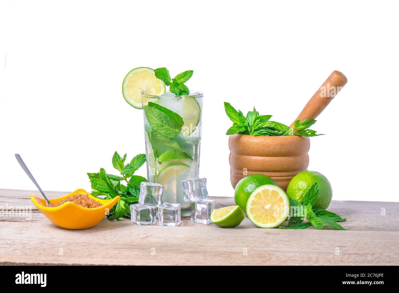 Mojito cocktail avec des ingrédients. Feuilles de menthe, de citron vert et de la glace pilée, morter avec la menthe et le sucre brun sur un fond de bois. D'Alcool rafraîchissant Banque D'Images