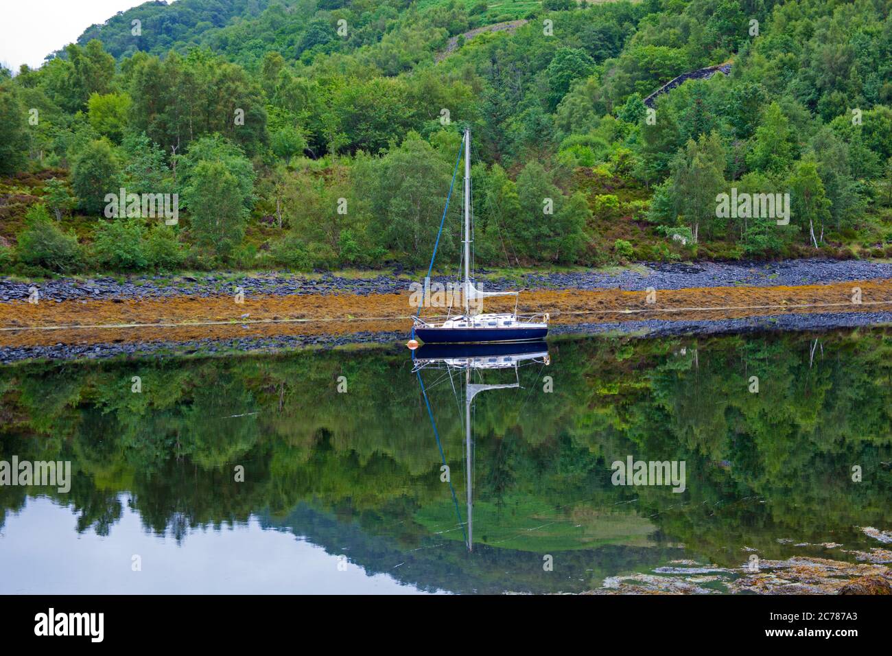 Ballachulish, Lochaber, Écosse, Royaume-Uni. 15 juillet 2020. Après une lourde pluie de nuit, le matin a commencé par la brume sur les collines et les montagnes en arrière-plan, avec peu ou pas de vent sur le Loch Leven permettant des réflexions presque parfaites de la petite embarcation et des conditions parfaites pour le milieu. La pluie s'est mise en place peu après pour accueillir les visiteurs qui s'aventuraient dans la région, car les grands hôtels sont autorisés à ouvrir, ainsi que les pubs et les bars pouvant servir les clients à l'intérieur. Banque D'Images