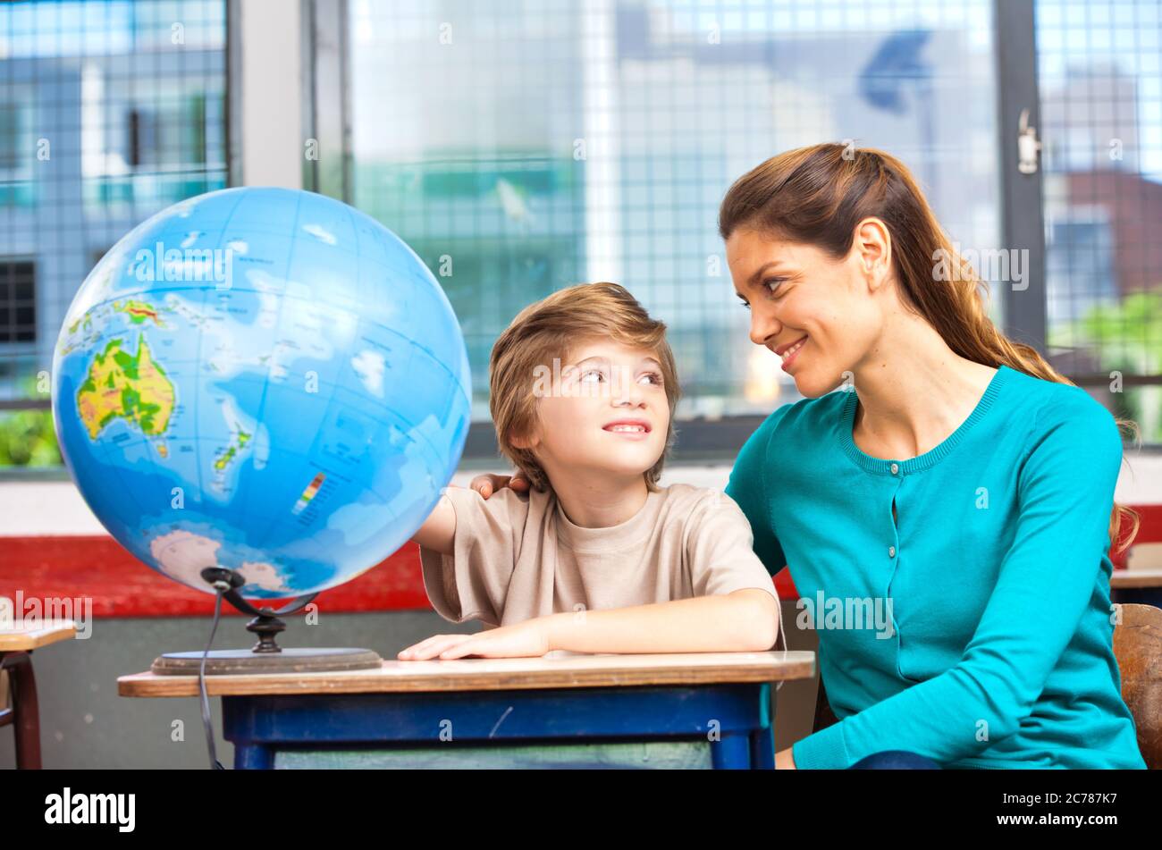 Scène de l'école élémentaire. Enseignant avec élèves en classe. Banque D'Images