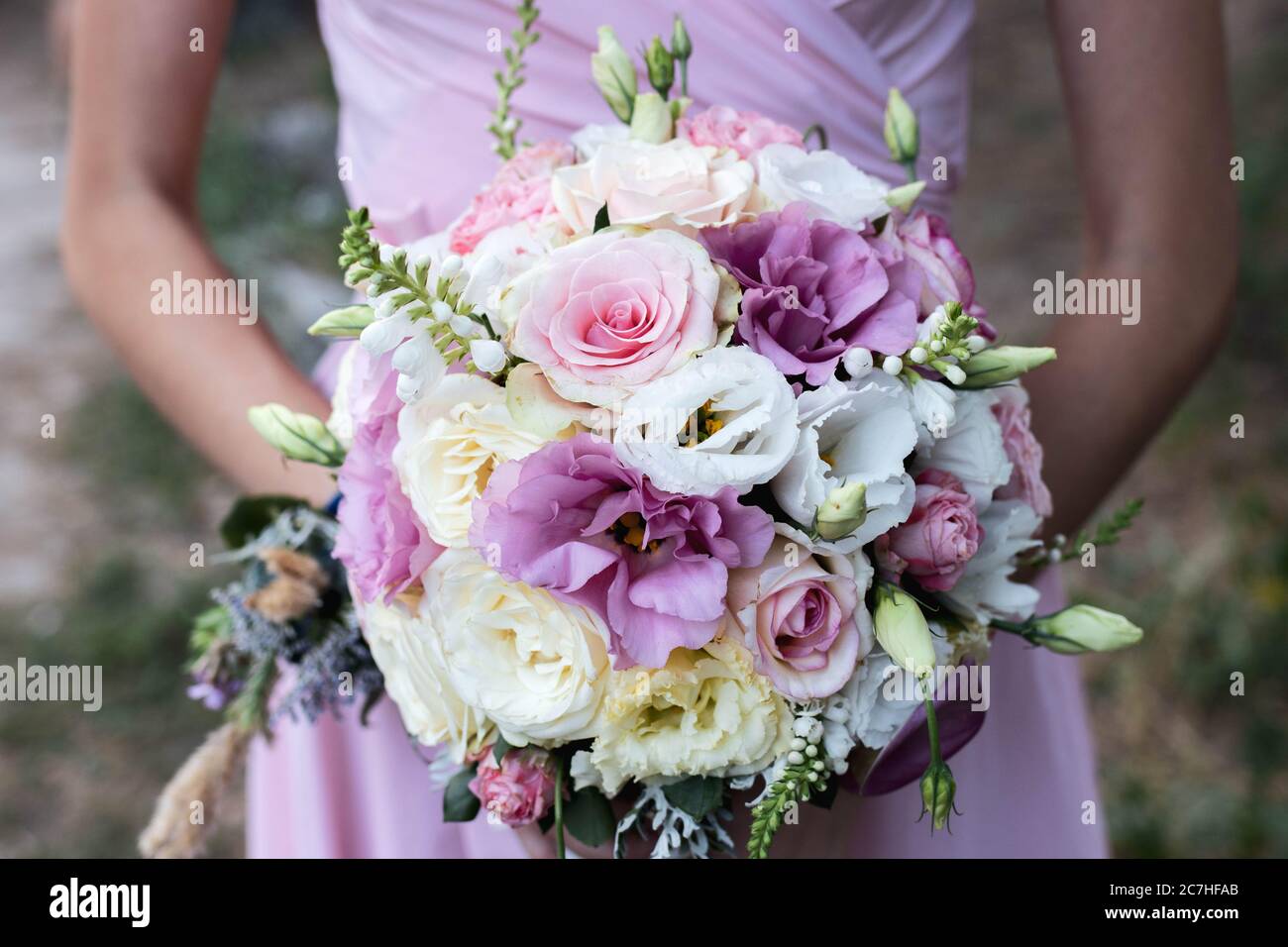 Bouquet de mariée de fleurs roses et violettes entre les mains d'un ami  Photo Stock - Alamy